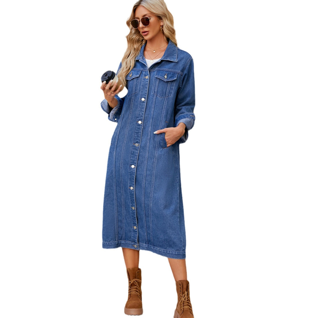Woman in washed blue long denim coat, street style