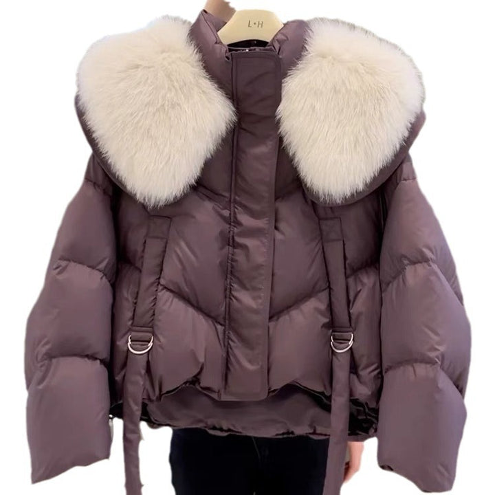 Woman wearing black padded winter coat with fur collar