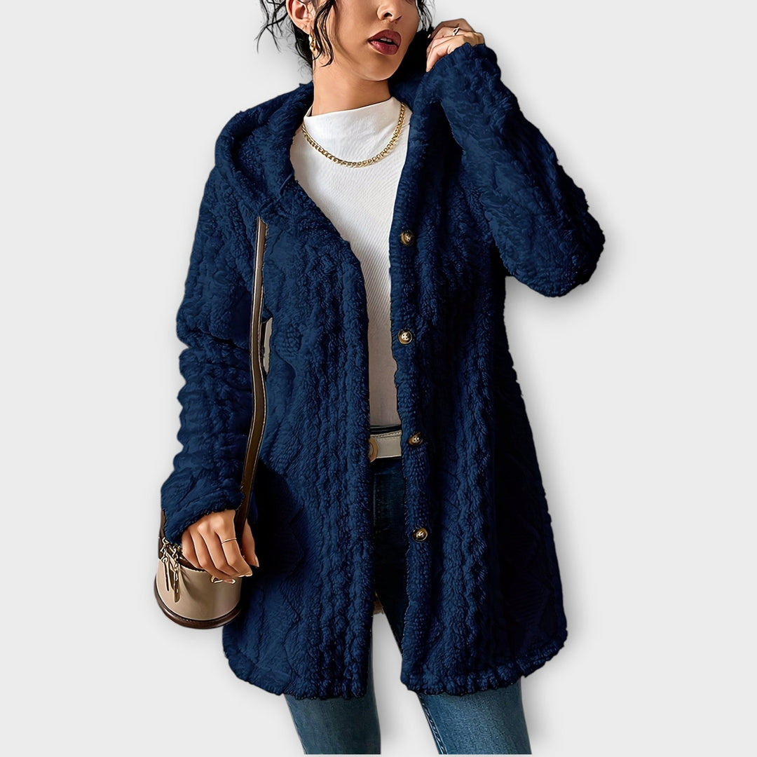Woman wearing textured hooded winter jacket with relaxed fit