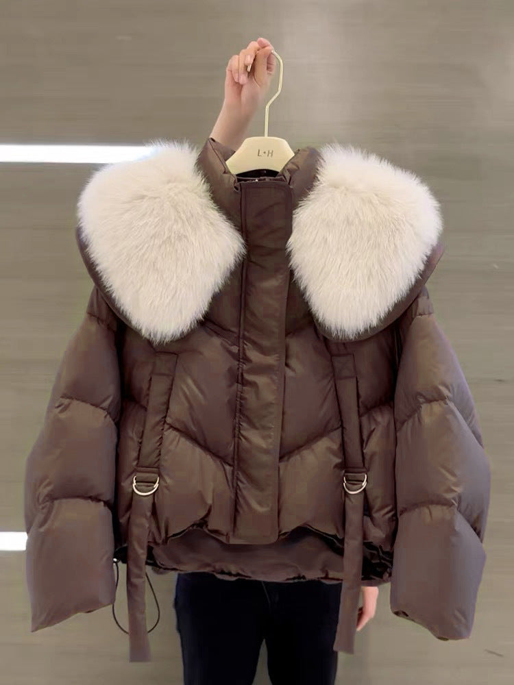 Woman wearing black padded winter coat with fur collar