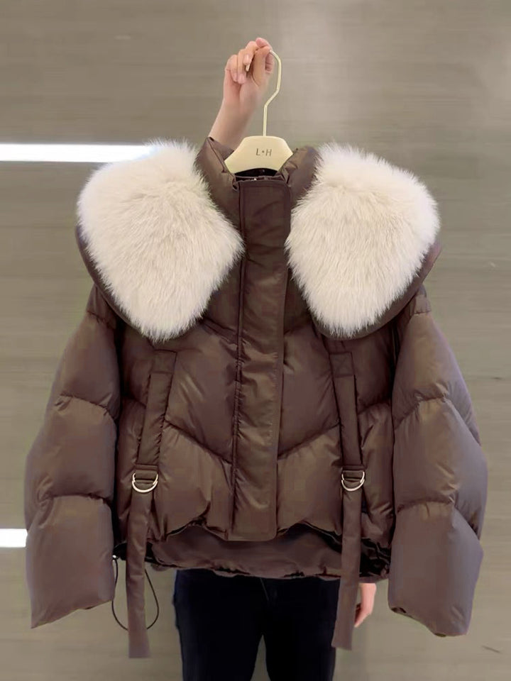 Woman wearing black padded winter coat with fur collar