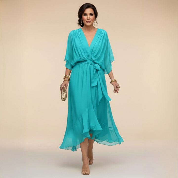 Woman wearing flowy V-neck dress, front view