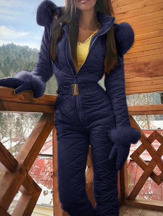 Woman wearing hooded winter ski coat in navy blue