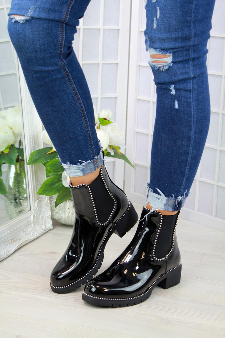 Woman wearing black short martin boots with round toe