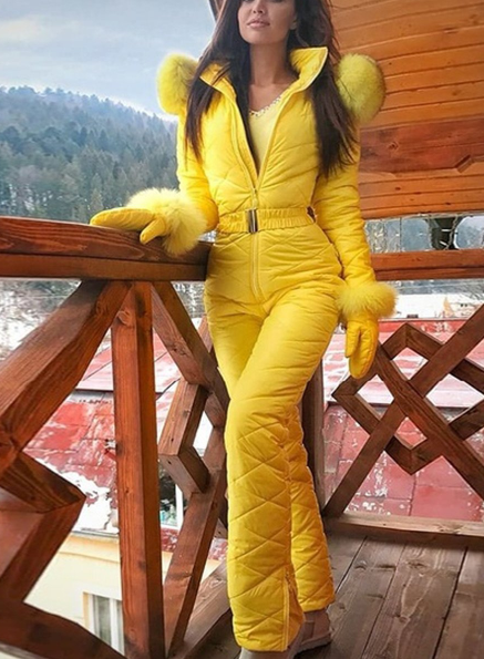 Woman wearing hooded winter ski coat in navy blue