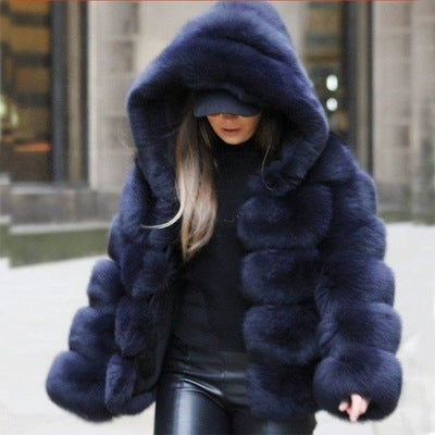 Woman wearing a fluffy faux fur short coat with hood