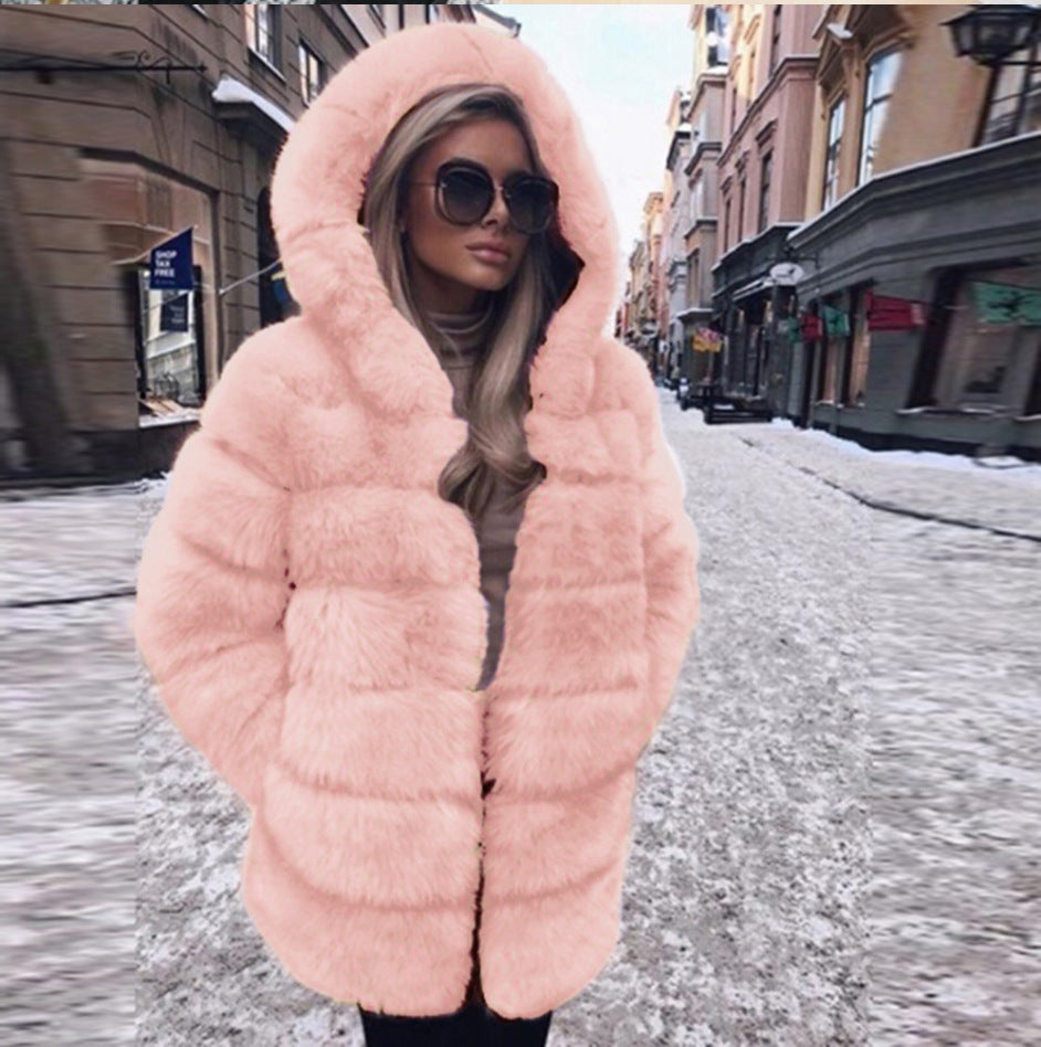 Woman wearing a fluffy faux fur short coat with hood