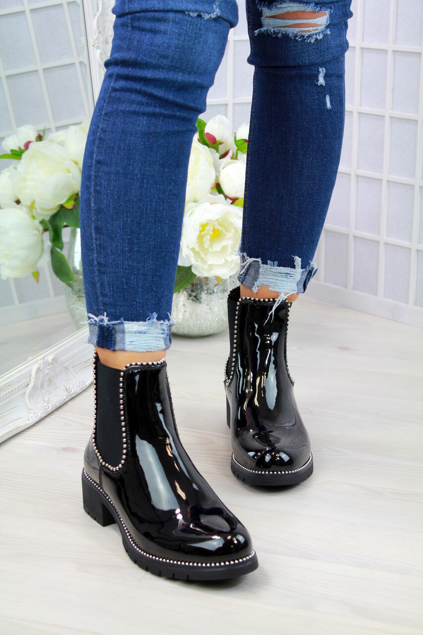 Woman wearing black short martin boots with round toe