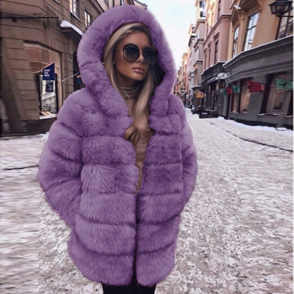 Woman wearing a fluffy faux fur short coat with hood