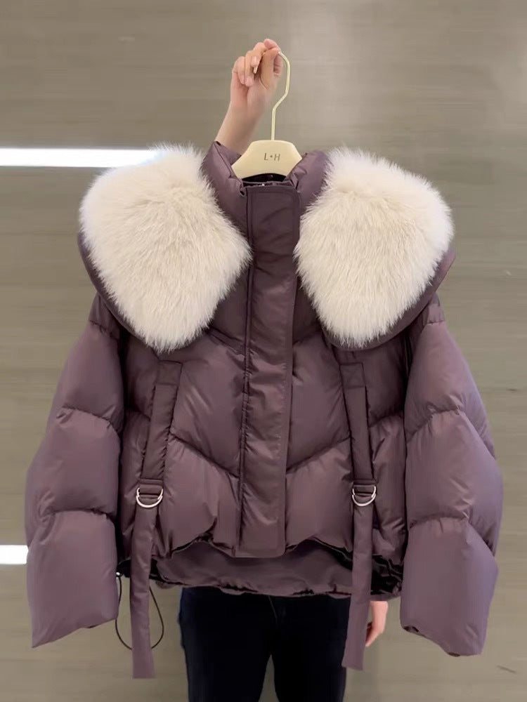 Woman wearing black padded winter coat with fur collar