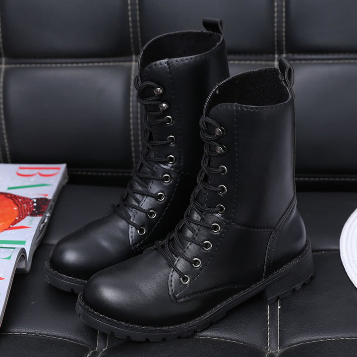 Women's black lace-up combat boots with rivets