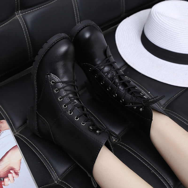 Women's black lace-up combat boots with rivets