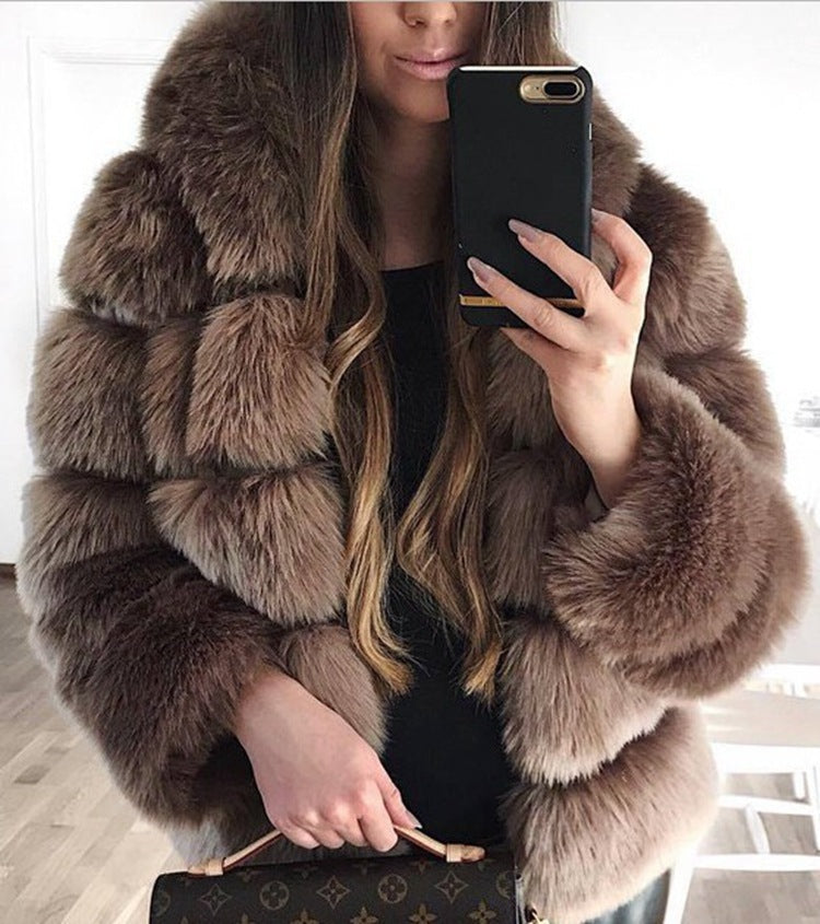 Woman wearing a fluffy faux fur short coat with hood