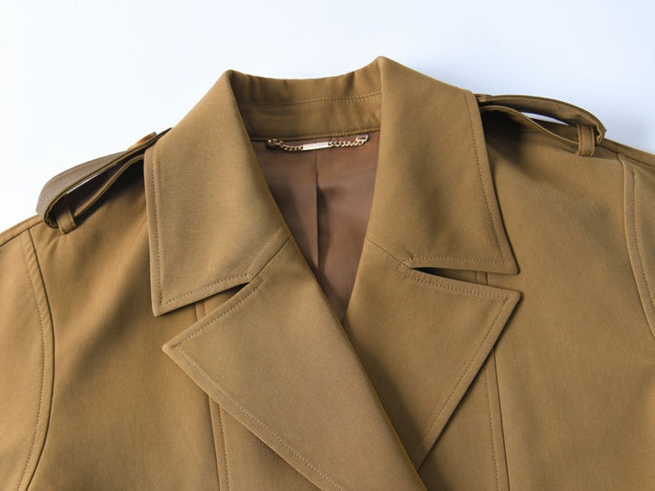 Woman wearing khaki short trench coat with long sleeves