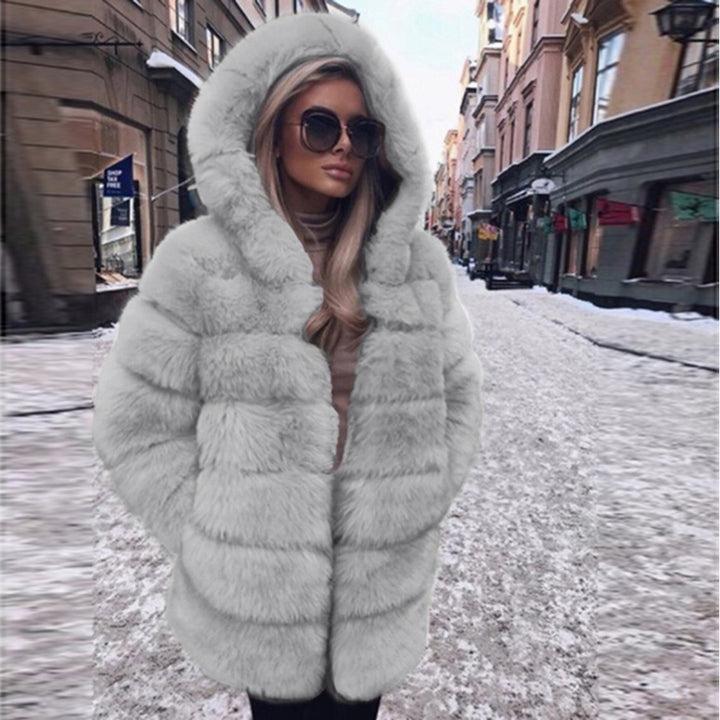 Woman wearing a fluffy faux fur short coat with hood