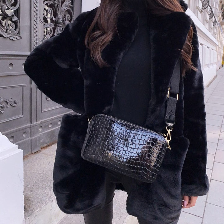 Woman wearing long faux fur coat with lapel collar