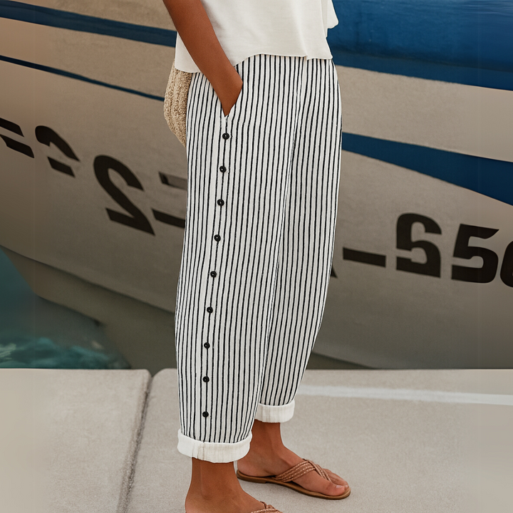 Woman wearing black striped high waisted button pants