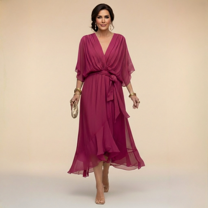 Woman wearing flowy V-neck dress, front view