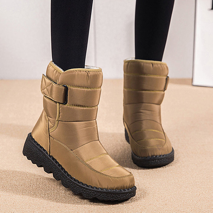 Woman wearing black plush-lined snow boots with buckle