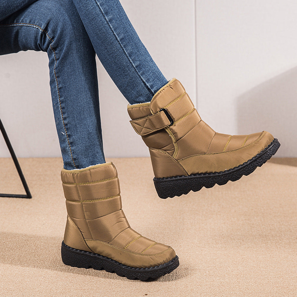Woman wearing black plush-lined snow boots with buckle