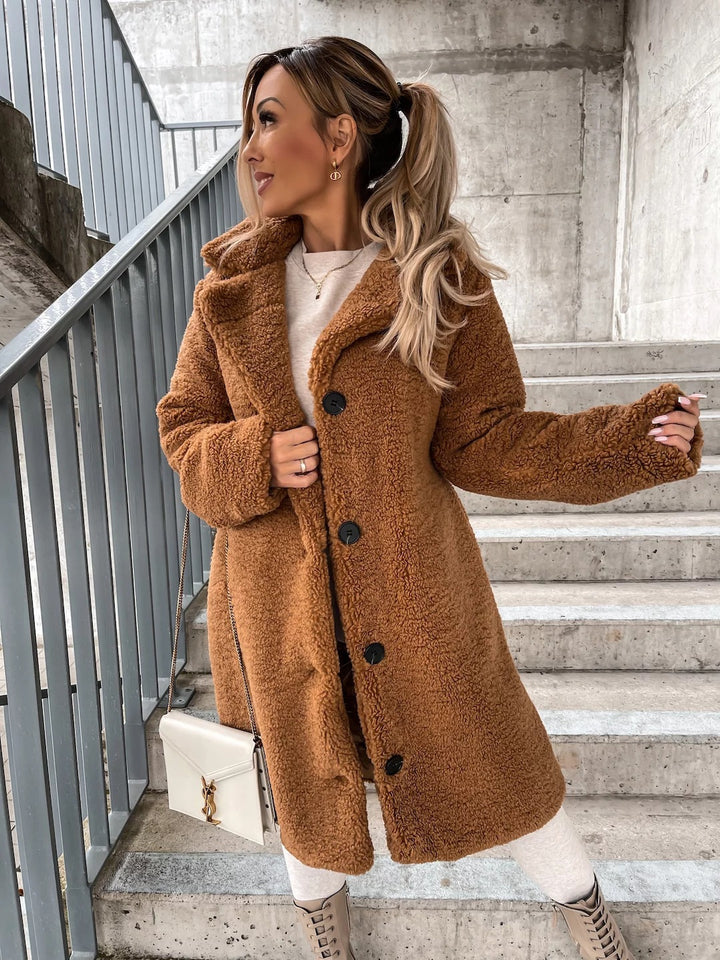 Woman wearing long lapel coat with fur collar