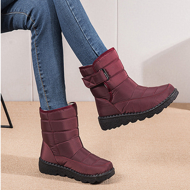 Woman wearing black plush-lined snow boots with buckle
