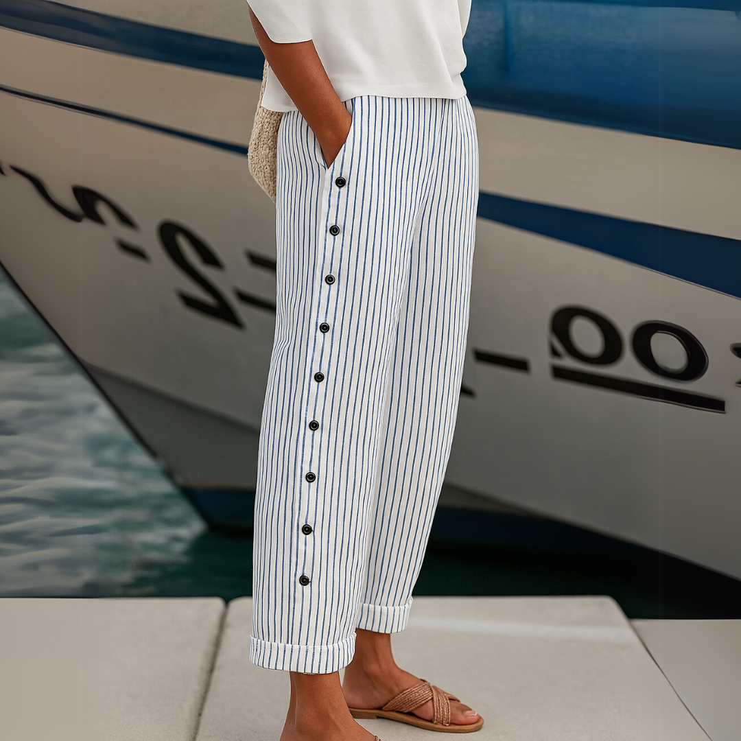 Woman wearing black striped high waisted button pants