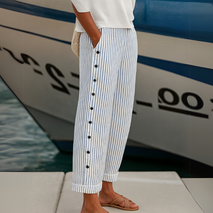 Woman wearing black striped high waisted button pants