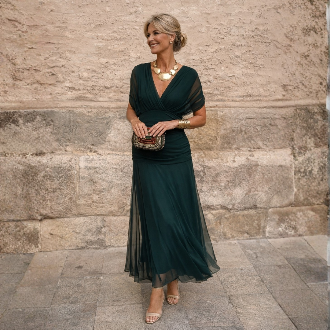 Woman wearing draped maxi dress with deep V-neck