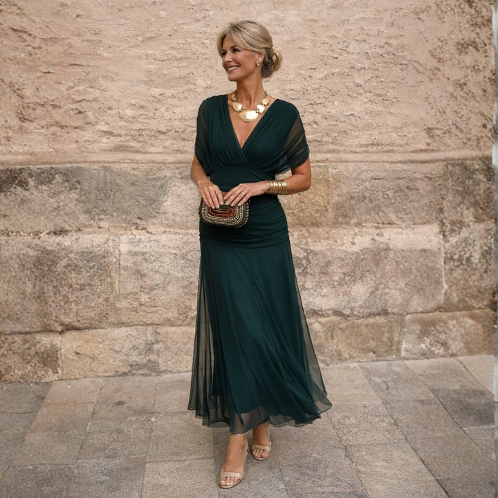 Woman wearing draped maxi dress with deep V-neck