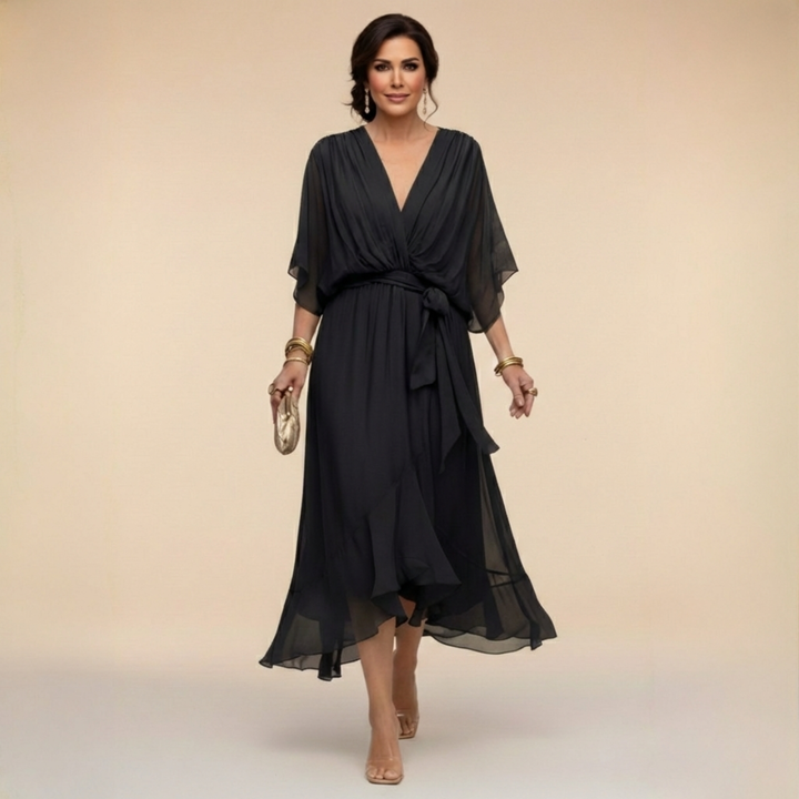 Woman wearing flowy V-neck dress, front view