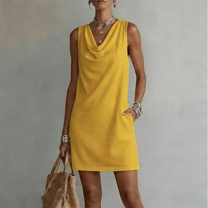 Woman wearing sleeveless mini dress with draped neckline