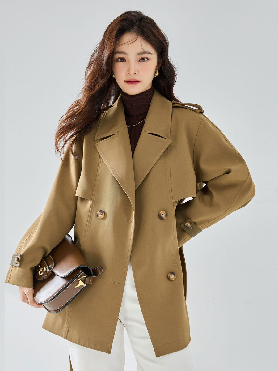 Woman wearing khaki short trench coat with long sleeves