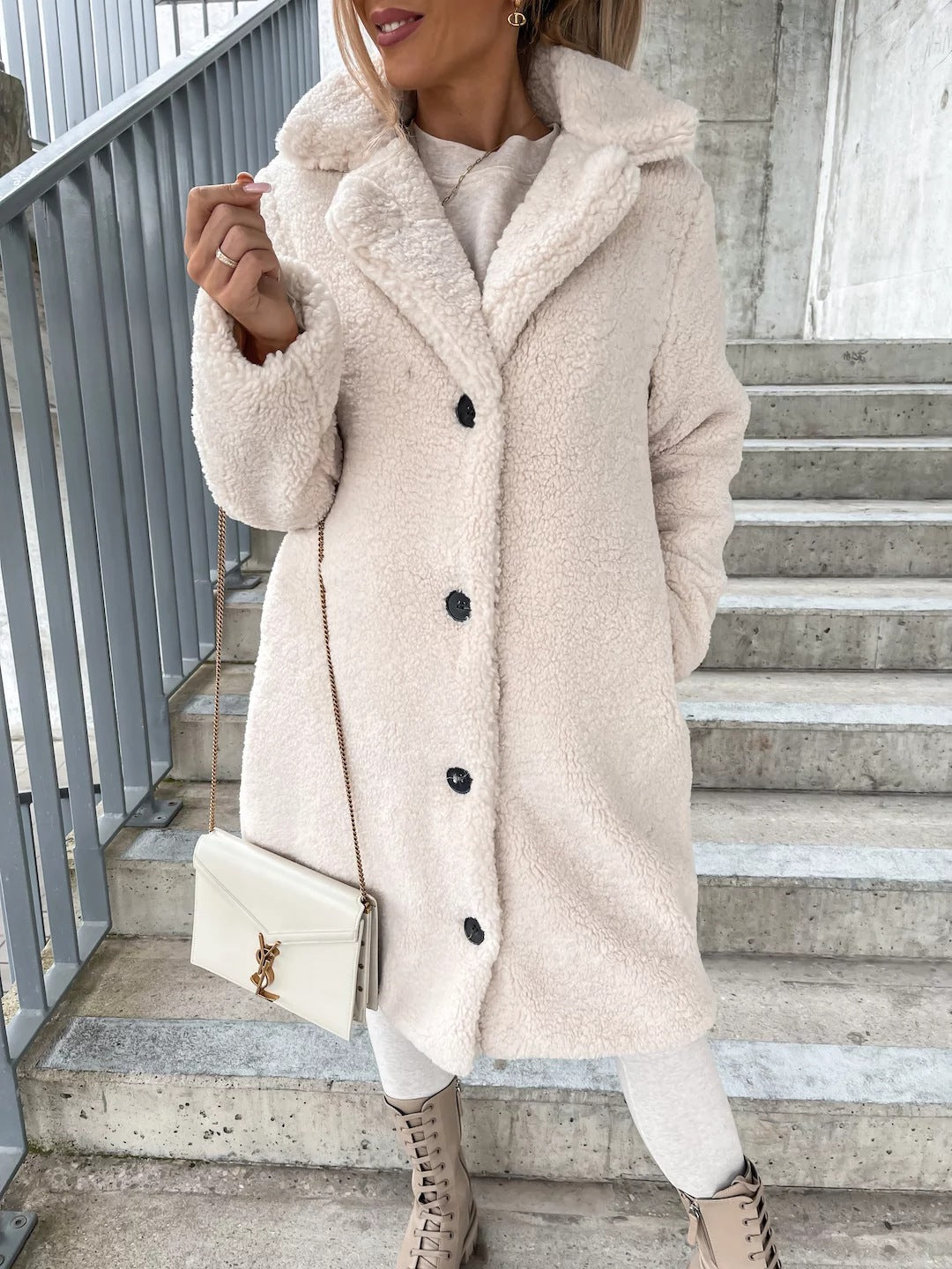 Woman wearing long lapel coat with fur collar