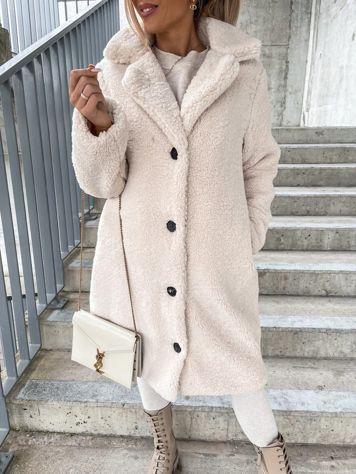 Woman wearing long lapel coat with fur collar