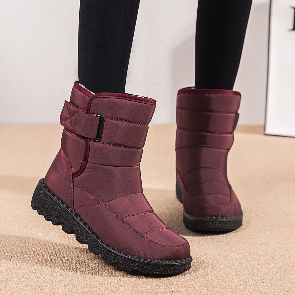 Woman wearing black plush-lined snow boots with buckle