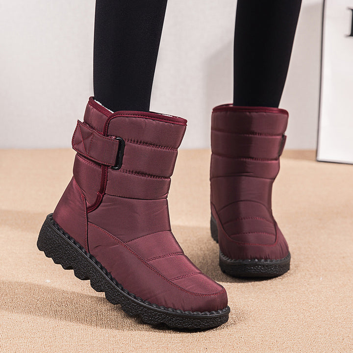 Woman wearing black plush-lined snow boots with buckle