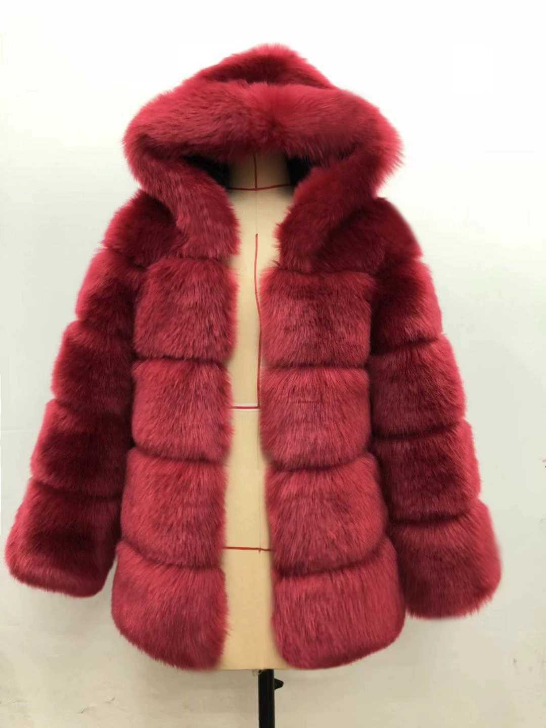 Woman wearing a fluffy faux fur short coat with hood