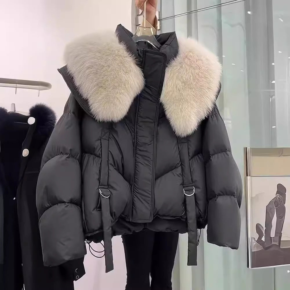 Woman wearing black padded winter coat with fur collar