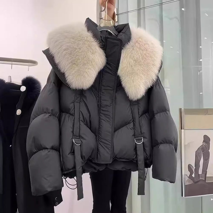 Woman wearing black padded winter coat with fur collar