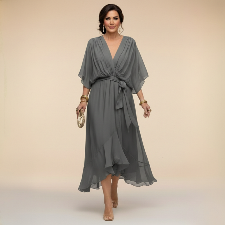 Woman wearing flowy V-neck dress, front view