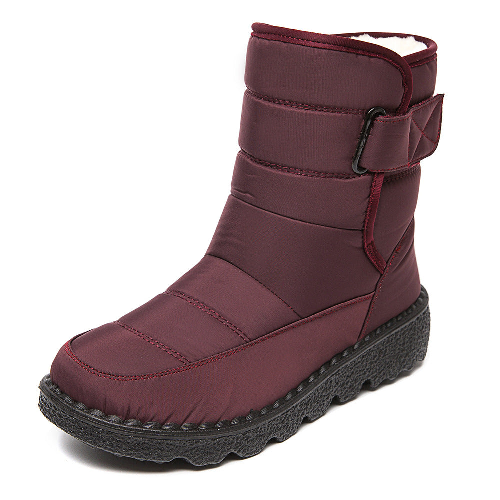 Woman wearing black plush-lined snow boots with buckle