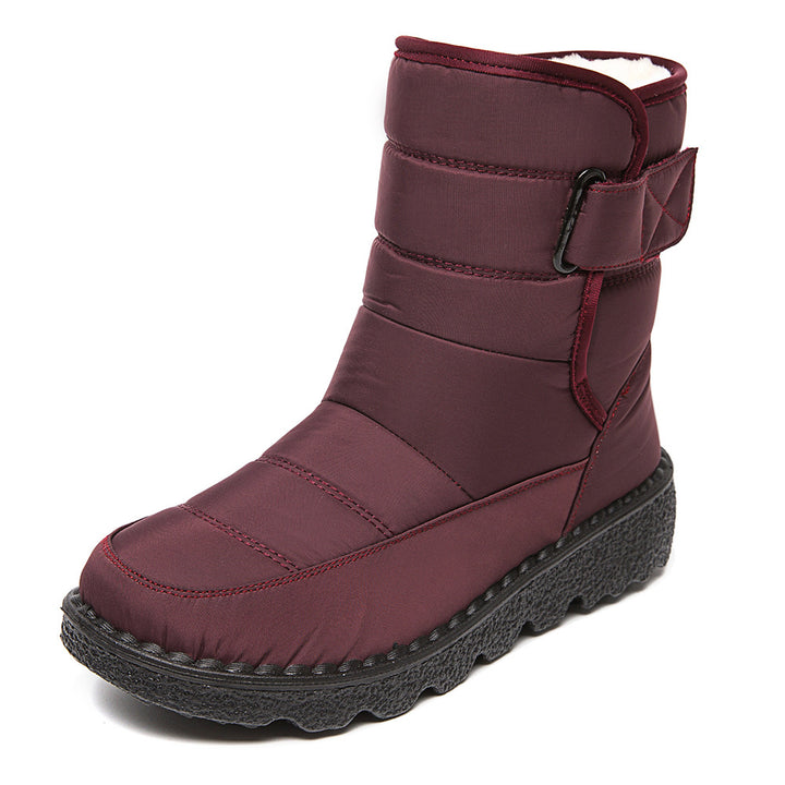 Woman wearing black plush-lined snow boots with buckle