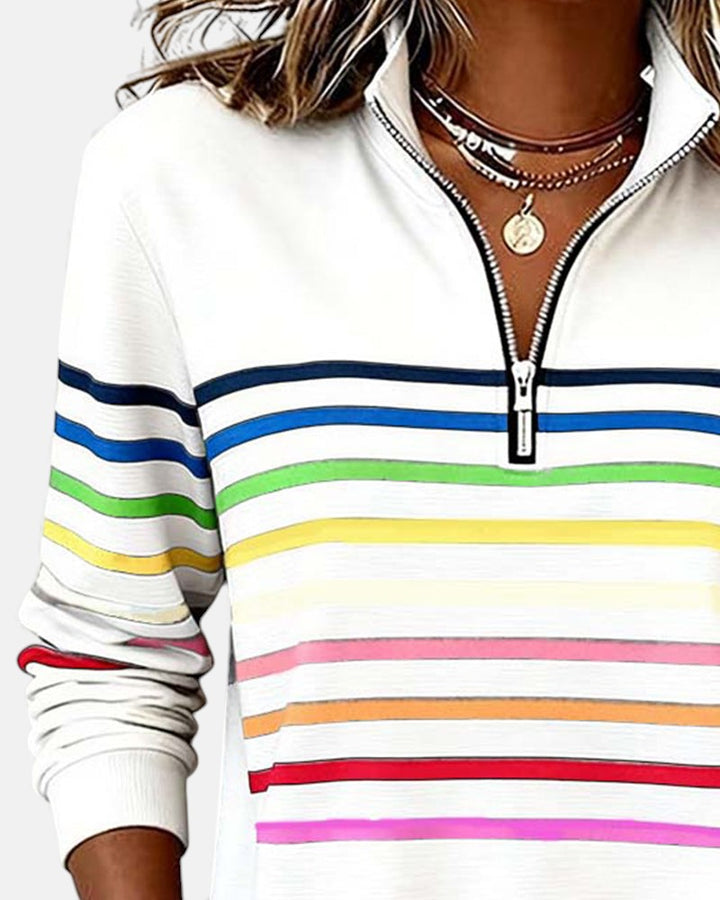 Woman wearing rainbow striped zip sweatshirt with stand collar