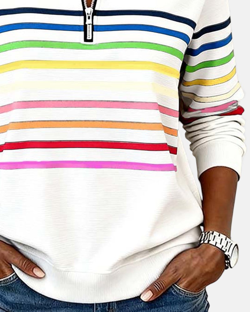 Woman wearing rainbow striped zip sweatshirt with stand collar