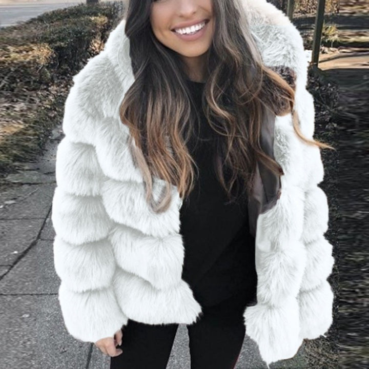 Woman wearing a fluffy faux fur short coat with hood
