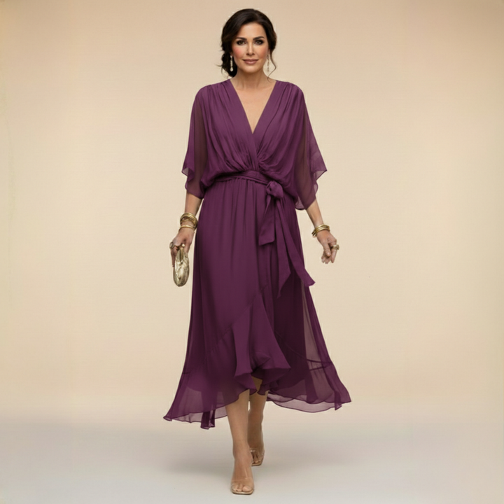 Woman wearing flowy V-neck dress, front view