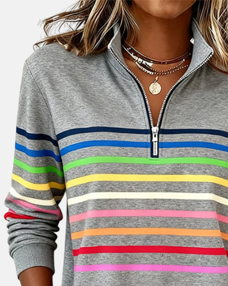Woman wearing rainbow striped zip sweatshirt with stand collar