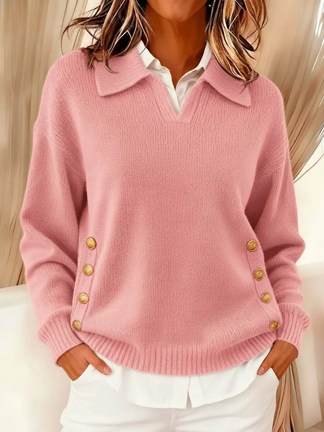 Woman wearing V-neck collared sweater with gold buttons
