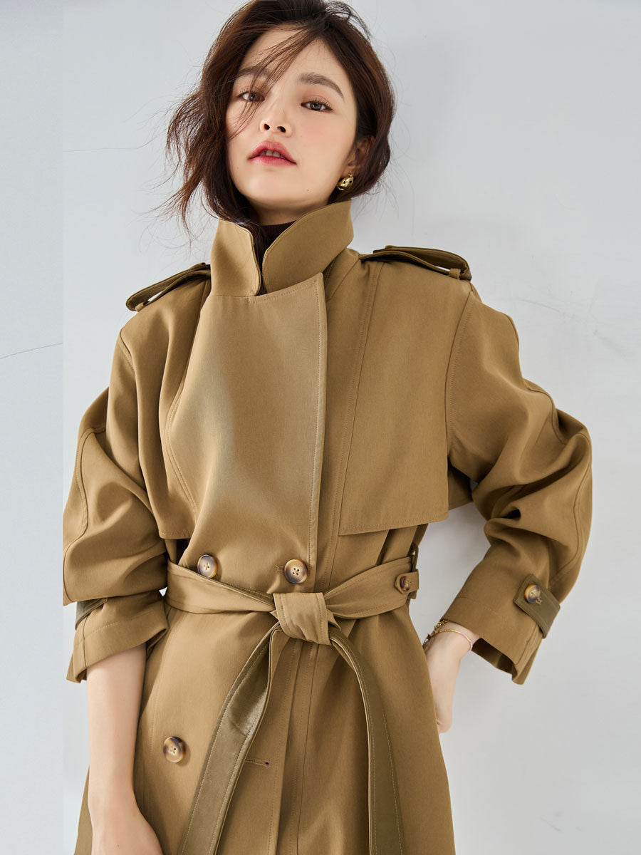 Woman wearing khaki short trench coat with long sleeves